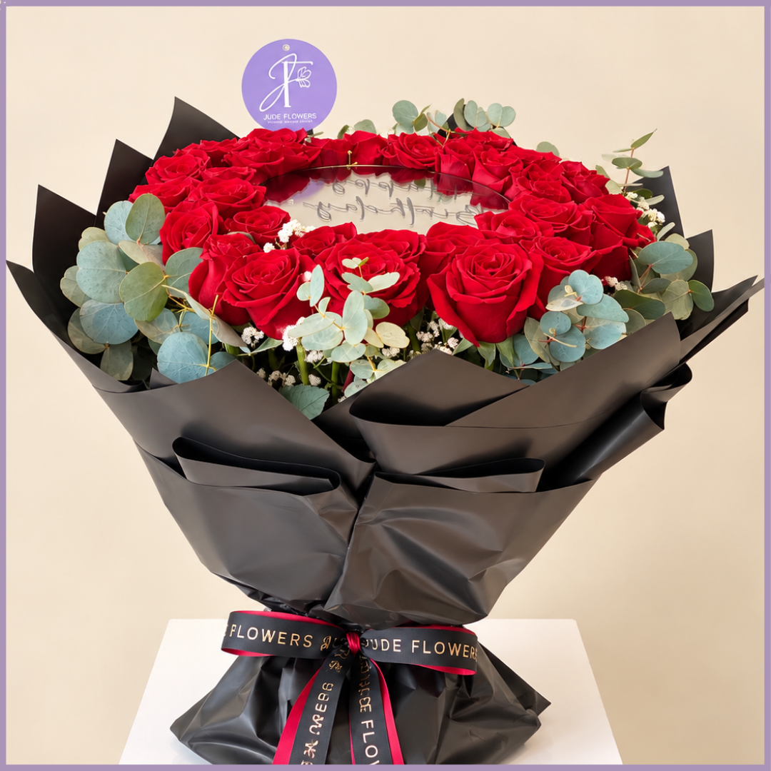 Crimson Reflection bouquet with 30 red roses arranged around a central mirror in black wrapping