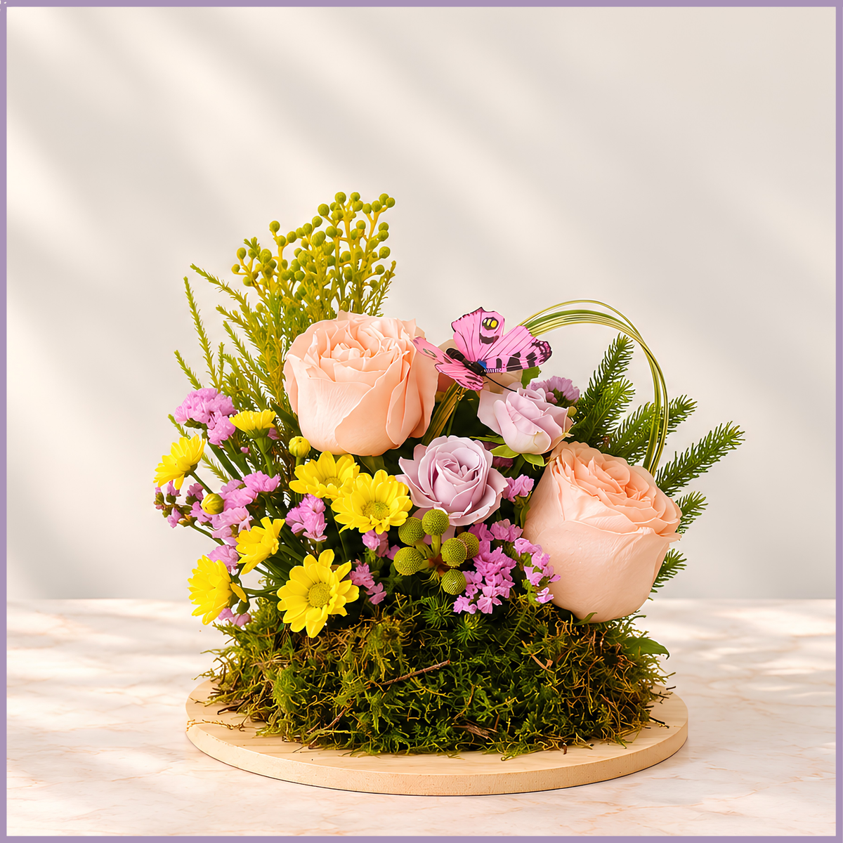 Petite Bliss pink rose and santini floral arrangement on a moss base with decorative butterfly – Jude Flowers Bahrain